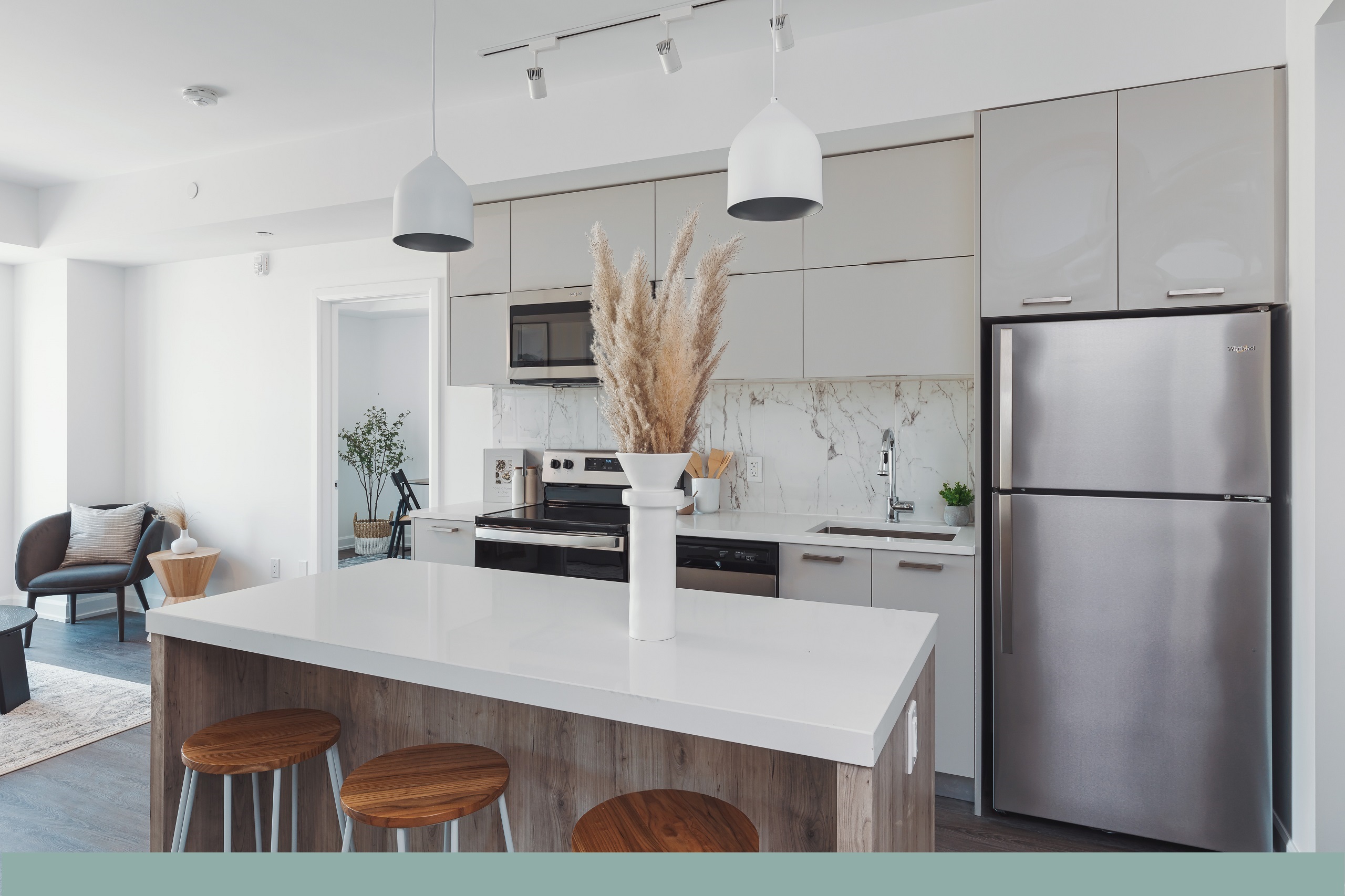 Living area of Switzer apartment with luxury vinyl tile flooring and wood grain finishes